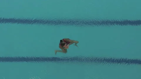 AERIAL DRONE TOP-DOWN  Synchronized Swimming ATHLETE Stock Footage 130338740
