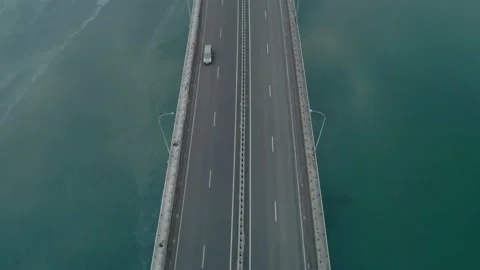 Aerial drone top down tilt view of low-water bridge across the bay with moving Stock Footage 151025317