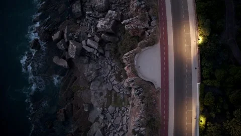 Aerial drone top down timelapse video of a road next to cliffs and ocean Stock Footage 252189509