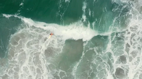 Aerial drone top down tracking surfer in tropical sea wave BR UBA 0761 A GR Stock Footage 143286536