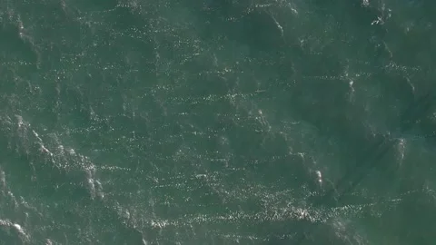 Aerial drone top down video of luxury yacht cruising in deep blue open ocean sea Stock Footage 188575932