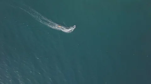 Aerial Drone Top Down View of Jet Ski riding inflatable banana boat in ocean Stock Footage 128030040