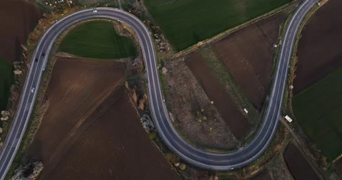 Aerial drone top down view of cars driving on a beautiful S Curved Stock Footage 201488874