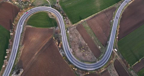 Aerial drone top down view of cars driving on a beautiful S Curved Video stock 201490733