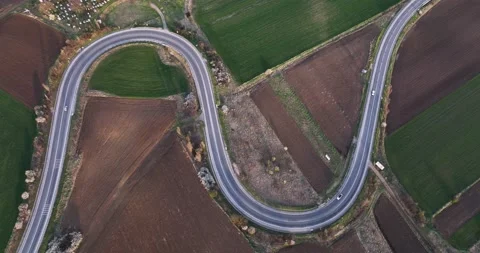Aerial drone top down view of cars driving on a beautiful S Curved Video stock 201490883