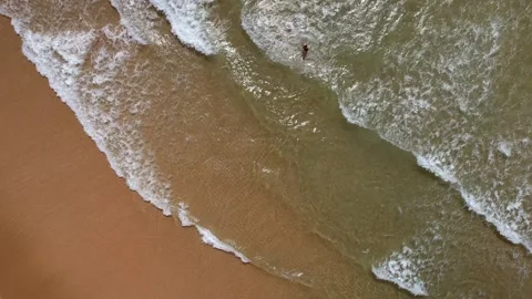 Aerial drone top down view of unidentifitable young man diving in at an idyllic Stock Footage 207420653