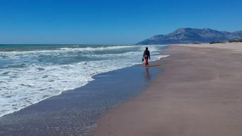 Aerial drone top down view of woman walking alone the beach. Patara Turkey 스톡 동영상 220340135