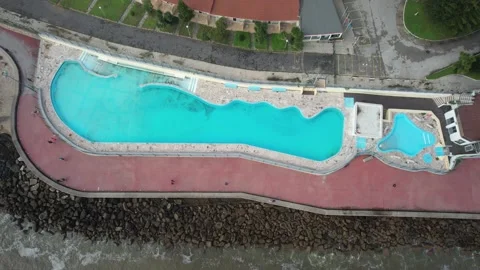 Aerial drone top down view of large swimming pool next to sea Stock Footage 226607955