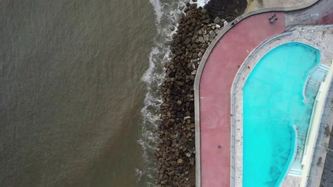 Aerial drone top down view of large swimming pool next to sea Stock Footage 226608065