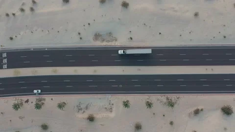 Aerial drone top down view of a semi truck with a long trailer traveling on a Видео 233853245