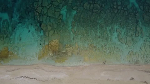 Aerial drone top down view of wild beach with clear blue water Video stock 245538739