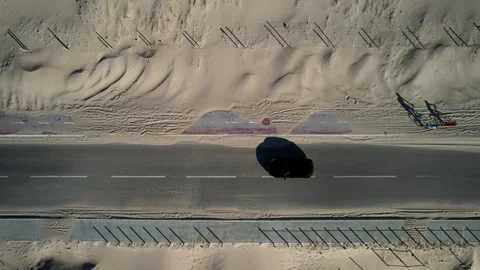 Aerial drone top down view of vehicles on the N247 hugging the coast of Guincho Stock Footage 245982491