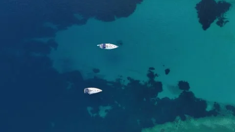 Aerial drone top down view of two yachts anchored in the Aegean Sea Stock Footage 279582069