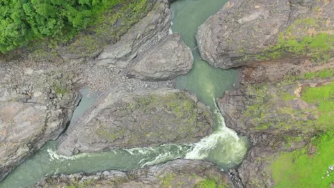 Aerial drone top down view of River milky water, cliffs and rocky area. Stock Footage 285585776
