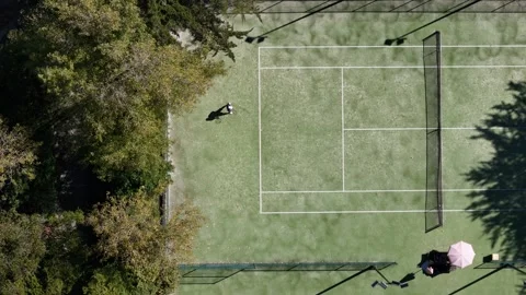 Aerial drone top down view of an unidentifiable person playing tennis Stock Footage 286222018