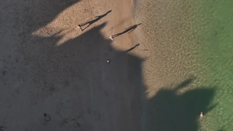 Aerial drone top down view of teenagers playing football on the beach Stock Footage 312708011