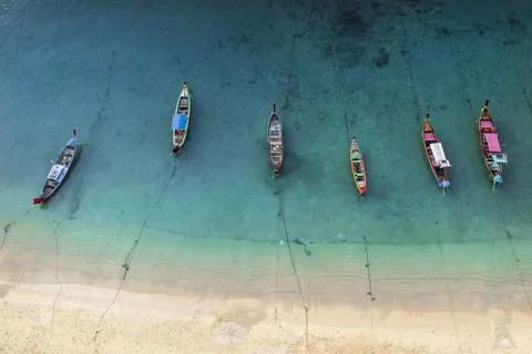 Aerial drone top down view of fishing boats in the shore during low tide. Top Stock Photos