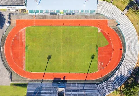 Aerial drone top down view of soccer stadium. Football stadium  with running  Stock Photos
