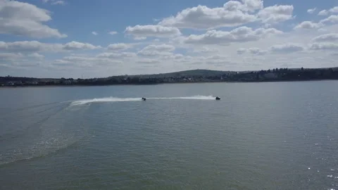 Aerial drone top view of 2 couple on jet ski watercraft manoeuvring in tropical Stock Footage 214260640