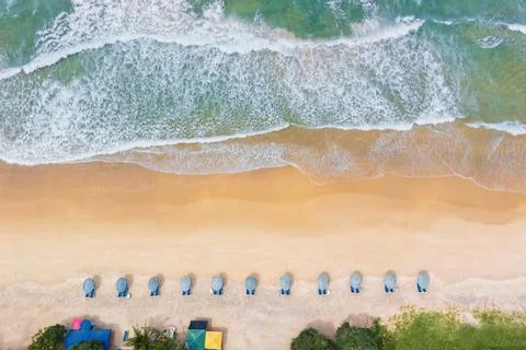 Aerial drone top view crowd of happy people relax at tropical Beach with suns Stock Photos