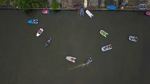 Aerial drone top view of multi-colored boats with a motor sail near the shore 库存影片 220520300