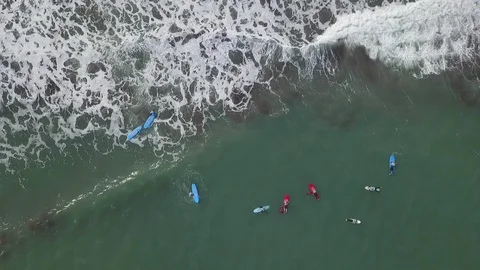 Aerial drone top view over surfers at Madeira island ocean wating to surf a wave Stock Footage 122225554