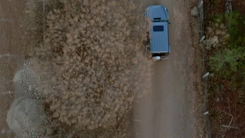 Aerial Drone Top View of SUV Driving Along Rural Dirt Road in Mexico Stock Footage 342235456