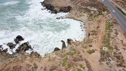 Aerial drone top view waves break on rocks in a blue ocean. 스톡 동영상 168251314