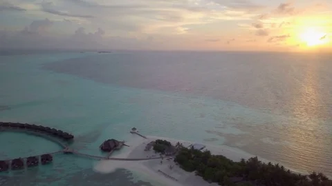 Aerial Drone Tracking and Pan from Sunset to Water Villas Vídeos de archivo 80945009