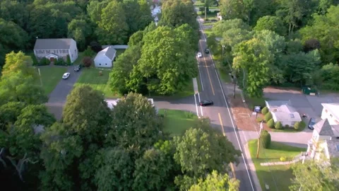 Aerial Drone Tracking Black Auto Through Residential Neighborhood Stock Footage 160072010