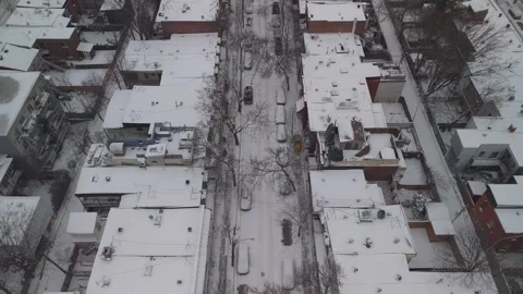 Aerial Drone Tracking Forwards Above Snow Removal Vehicle In Montreal Streets 4K 動画素材 272681368