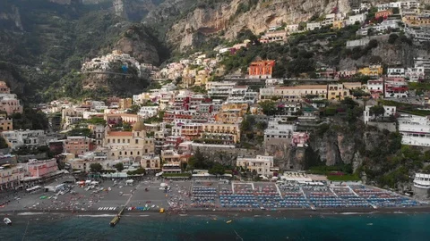 Aerial drone tracking pull back revealing from buildings of Positano city to sea Stock Footage 113704116