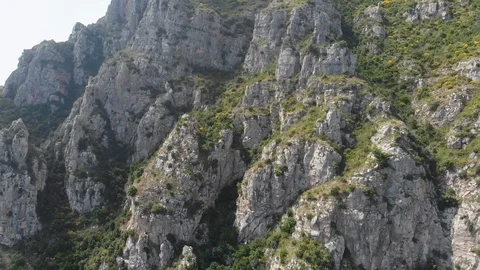 Aerial drone tracking pullback revealing mountainous road near rock cliffs Stock Footage 113702562