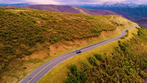 Aerial Drone Tracking Shot Of Car Driving in the Mountains in Fall Video stock 290065249