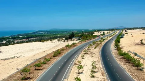 Aerial drone tracking shot of an empty two-lane desert highway 4K Stock Footage 338369368