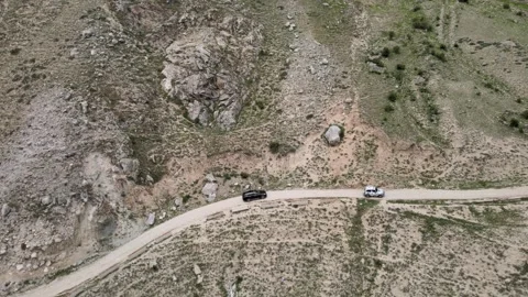 Aerial drone tracking shot of vehicles in the Bezengi Gorge Stock Footage 337396523