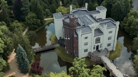 Aerial Drone Turning Left Over Kornik Castle with People Walking on Path Stock Footage 323772602