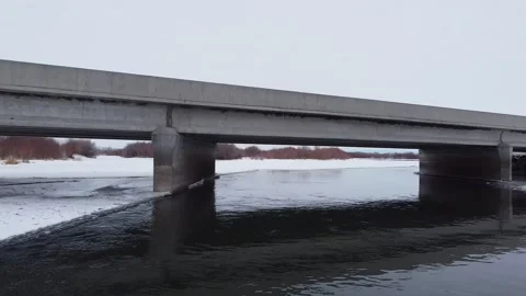 Aerial Drone Under Bridge, Over Frozen Snake River, Idaho Stock Footage 157134216