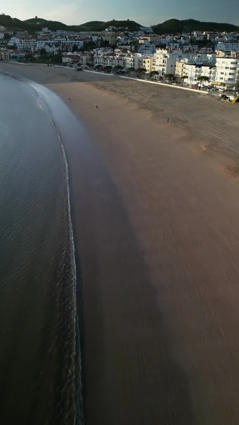 Aerial drone vertical view above Sao Martinho do Porto beach at sunset, Portugal Stock Footage 276241956