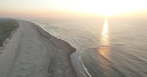 Aerial drone video of couple walking romantic beach walking at sunset. Stock Footage 293203553