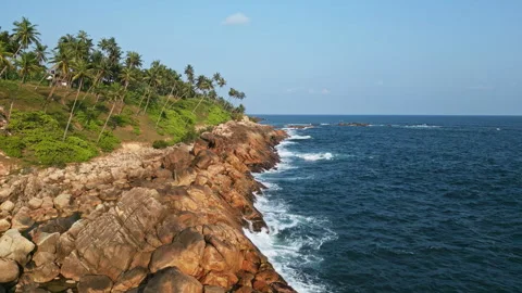 Aerial drone video of dynamic ocean waves hitting tropical coast with rocks and Stock Footage 270004178