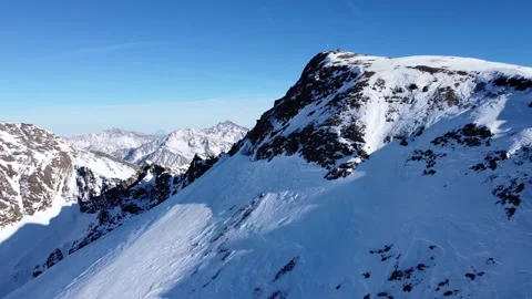Aerial drone video of forward flight over snowy mountain ridge Stock Footage 234323907