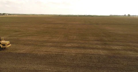 Aerial drone video of the harvesting machine in the field. The tractor plowing a Video stock 80747669