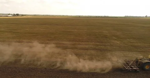 Aerial drone video of the harvesting machine in the field. The tractor plowing a Video stock 80747706