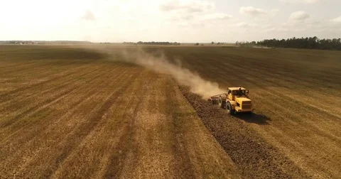 Aerial drone video of the harvesting machine in the field. The tractor plowing a Video stock 80747822