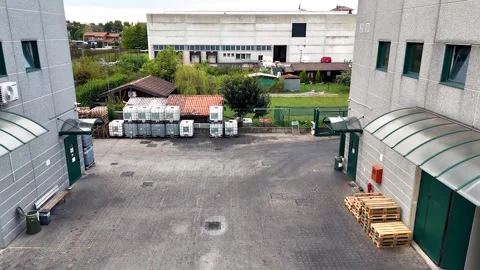 Aerial drone video of opening between industrial buildings at a plant Stock Footage 311998392