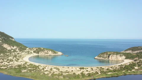 Aerial drone video of semicircular sandy beach and lagoon of Voidokilia, one  Видео 158176085
