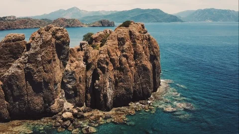 Aerial drone video of small island and boats beyong it Stock Footage 93331653