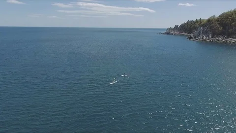 Aerial drone video of sup between 2 men in tropical caribbean waters Stock Footage 100981884