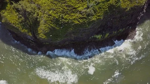 Aerial drone video top down view over rocky coastline with waves Video stock 77580894